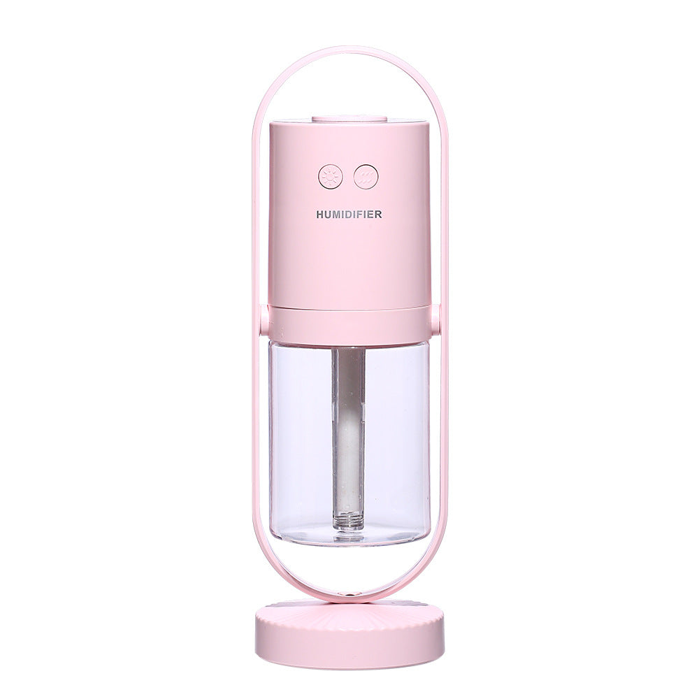 Magic Shadow USB air humidifier with projection night light in pink on wooden table
