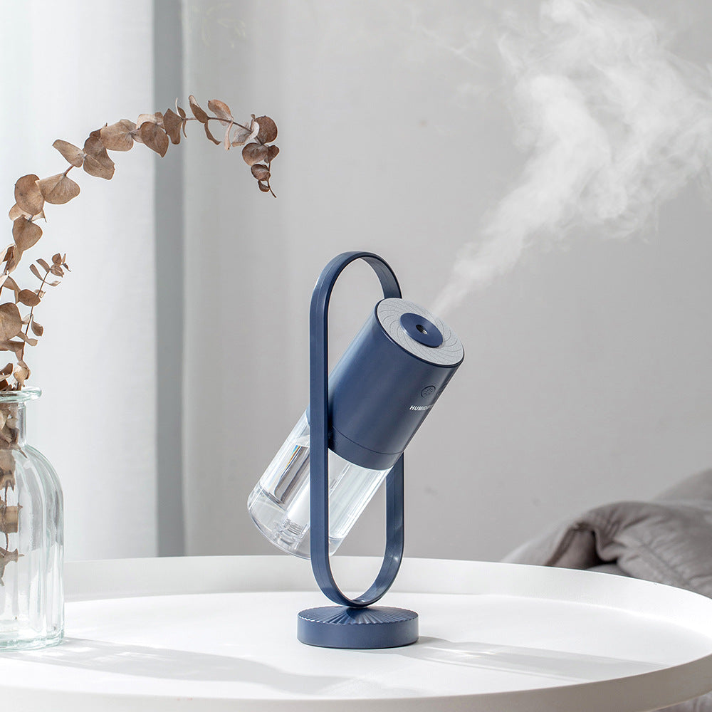 Magic Shadow USB air humidifier with projection night light on wooden table