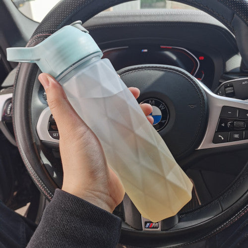 White plastic spray water bottle with handle strap, leakproof lid, and large capacity, ideal for girls' outdoor sports and fitness use